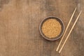 A bowl of rice and wooden chopsticks on sacking. Copy-paste. Space for text Royalty Free Stock Photo