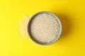 Bowl with rice on yellow background Royalty Free Stock Photo