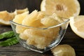 Bowl with ripe pomelo fruit slices on wooden table Royalty Free Stock Photo