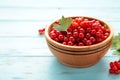 Bowl with ripe red currant on blue wooden background. Top view Royalty Free Stock Photo