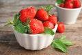 Bowl with ripe red strawberries and mint on table Royalty Free Stock Photo