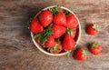 Bowl with ripe red strawberries on wooden background Royalty Free Stock Photo