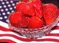 Bowl of ripe strawberries on 4th of July flag
