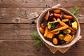 Bowl of roasted autumn vegetables, top view over rustic wood Royalty Free Stock Photo