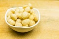 Bowl with roasted and salted macadamia nuts. Royalty Free Stock Photo