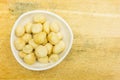 Bowl with roasted and salted macadamia nuts. View from above. Royalty Free Stock Photo