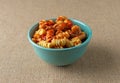 Bowl of rotini in a sausage and pasta sauce on a tablecloth