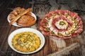 Bowl Of Russian Salad With Appetizer Savory Dish Meze And Bunch Of Sesame Croissant Puff Pastry Served On Old Garden Table