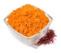 Bowl with saffron powder and dried flower stigmas on white background Royalty Free Stock Photo