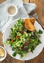 Bowl salad green mache leaves baked tomatoes top view Royalty Free Stock Photo