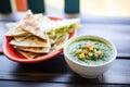 bowl of salsa verde with a side of quesadillas