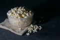 Bowl with salted popcorn on a black table, selective focus Royalty Free Stock Photo