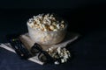 Bowl with salted popcorn, a TV remote and glasses on a black table, selective focus Royalty Free Stock Photo