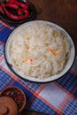 Bowl of sauerkraut, sour pickled cabbage and carrots with hot chilli red pepper and spices. Piquant salad with vitamin C from