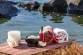 Bowl with sea salt, bottles with aromatic oil, candle, orchid fl