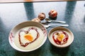 bowl of Semolina porridge with some fruit and shape of heart jam