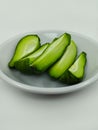 a bowl of several pieces of boiled chayote on a white background