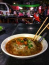A bowl of Shan Noodles at the Chinese night market in Mandalay