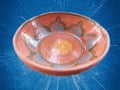 Bowl is shown in this picture. It is made of mud