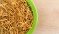 Bowl of shredded calendula flower petals on table