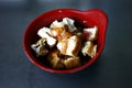 Bowl of sliced fried tofu in soy sauce