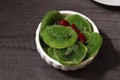 Bowl with slices of candied kiwi and cherry on dark gray wooden background, top view. Dried fruit as healthy food Royalty Free Stock Photo