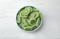 Bowl with slices of kiwi on wooden background. Dried fruit as healthy food Royalty Free Stock Photo