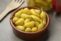 Bowl with small pickled yellow Turkish hot peppers close up