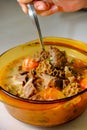 A bowl of Soto Betawi, Indonesian native traditional soup made of beef or beef offal cooked in coconut milk broth