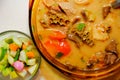 A bowl of Soto Betawi, Indonesian native traditional soup made of beef or beef offal cooked in coconut milk broth with pickles