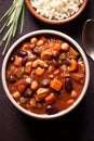 a bowl of soup with beans carrots and onions