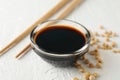 Bowl of soy sauce, soy beans on background, space for text. Closeup Royalty Free Stock Photo