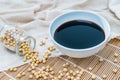 A bowl of soy sauce and sprinkled soybeans Royalty Free Stock Photo