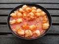 Bowl of spicy hot savory Seblak, traditional Indonesian food, made of wet krupuk cooked in a spicy sauce