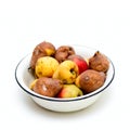 Bowl with spoilt pear isolated on white