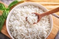 Bowl and spoon with boiled white rice on table Royalty Free Stock Photo