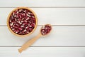 Bowl and spoon with dry kidney beans on white wooden table, flat lay. Space for text Royalty Free Stock Photo