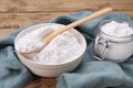 Bowl, spoon and glass jar of natural starch on wooden table, closeup Royalty Free Stock Photo