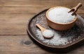 Bowl, spoon and scoop with natural sea salt on wooden table. Space for text Royalty Free Stock Photo