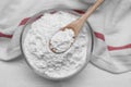 Bowl and spoon of starch on white wooden table, top view Royalty Free Stock Photo