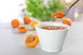 Bowl and spoon with tasty apricot jam Royalty Free Stock Photo