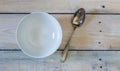 Bowl and spoon on used look wooden background