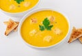 Bowl of squash soup with croutons and parsley leaf Royalty Free Stock Photo