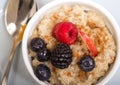 Bowl of steel cut oats served with fresh fruit and Royalty Free Stock Photo