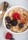 Bowl of steel cut oats served with fresh fruit and honey Royalty Free Stock Photo