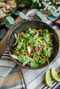 Bowl of stir fried udon noodles garnished with black sesame seeds and fresh mint with green chopsticks Royalty Free Stock Photo