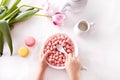 bowl with strawberry sweet corn balls. Delicious and healthy breakfast cereal. Kid hand take a spoon and eating Royalty Free Stock Photo