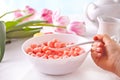 bowl with strawberry sweet corn balls. Delicious and healthy breakfast cereal. Kid hand take a spoon and eating Royalty Free Stock Photo
