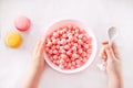 bowl with strawberry sweet corn balls. Delicious and healthy breakfast cereal. Kid hand take a spoon and eating Royalty Free Stock Photo