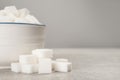 Bowl with sugar cubes on grey table, closeup. Space for text Royalty Free Stock Photo